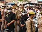 Cops and locals outside the building in the South Malaka locality of Prayagraj on Tuesday (HT Photo)