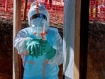 Health workers get dressed in personal protective equipment (PPE) at the Evangelical Medical Center in Bunia, Ituri province, Democratic Republic of Congo.