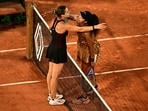 Japan's Naomi Osaka (R) and Aryna Sabalenka (L) embrace at the end of their women's singles match on day 9 of the French Open