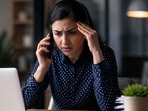 Woman reacting to a stressful work call.