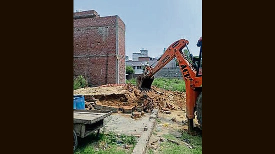 A building being demolished during the drive in Ludhiana on Tuesday. (HT Photo)