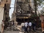 Police personnel at a site fire in a restaurant at Malviya Nagar, in New Delhi