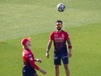 Virat Kohli warms up alongside Jordan Cox.