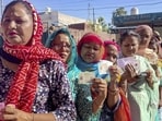 Women wait for their turn at a polling station in Amritsar during the Punjab municipal corporation elections on May 26. (PTI)