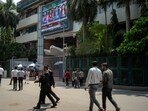 Pedestrians pass the Bombay Stock Exchange (BSE) building in Mumbai on April 20