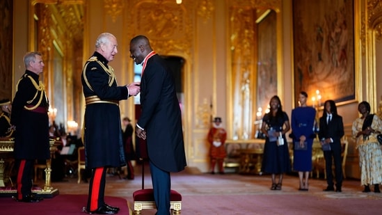 The Royal Family shared the photos from the investiture ceremony on their Instagram handle showcasing King Charles tapping a sword on Idris Alba's shoulders as he knelt to recieve his honour of knighthood.(Jordan Pettitt/PA via AP)