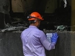 A forensic expert at the site of the Delhi fire on Wednesday. (HT Photo)