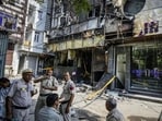 Delhi police personnel keep a vigil at the spot a day after a fire at the Flourish Stay B&B in Malviya Nagar killed at least 21 people. (RAJ K RAJ /HT PHOTO)