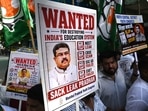 Indian Youth Congress party workers hold placards against Union education minister Dharmendra Pradhan during a protest on June 2.