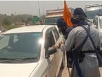 Nihang protesters stopping a commuter at the Gara Mora toll plaza on the Manali-Kiratpur highway on Wednesday. The protesters claim the collection was “voluntary donation” and a “symbolic protest” against the financial burden imposed by Himachal Pradesh’s entry taxes.