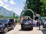 Vehicles carrying Jammu and Kashmir legislators MLAs and MPs arrive for a meeting in Srinagar on Wednesday. (PTI)