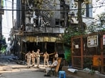 Delhi Police personnel keep a vigil at the spot a day after a fire at the Flourish Stay B&B killed at least 21 people, including 12 foreigners, at Hauz Rani area of Malviya Nagar in New Delhi, India, on Thursday, June 4, 2026. Delhi Police personnel keep a vigil at the spot a day after a fire at the Flourish Stay B&B killed at least 21 people, including 12 foreigners, at Hauz Rani area of Malviya Nagar in New Delhi, India, on Thursday, June 4, 2026.