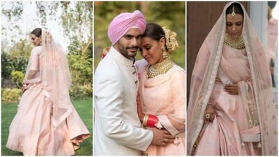 Neha Dhupia looked stunning on her wedding day in a gorgeous blush pink lehenga set. Crafted by Anita Dongre, the bridal ensemble was decorated with the designer's signature gota patti work. She offset the minimal lehenga with heirloom jewels. Neha Dhupia looked stunning on her wedding day in a gorgeous blush pink lehenga set. Crafted by Anita Dongre, the bridal ensemble was decorated with the designer's signature gota patti work. She offset the minimal lehenga with heirloom jewels. 