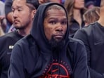 Kevin Durant was seen taking cover behind a large bush outside the restaurant while the unidentified woman remained inside. 