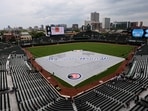 The tarp covers the baseball diamond due a rain delay before a baseball game between the San Fransisco Giants and the Chicago Cubs at Wrigley Field, Friday, June 5, 2026, in Chicago. (AP Photo/Geoff Stellfox)
