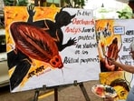 A man works on a poster on Cockroach Janta Party (CJP) ahead of CJP's protest on June 6th.