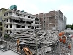 Rescue personnel at the site of the building collapse in Saidulajab on Sunday. (HT Photo)