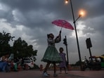 Children enjoy the pleasant weather after rainfall brings down the temperatures in Delhi on Thursday