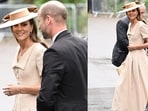 The cream-coloured dress featured a folded collar, button detailing, a belted waist and a flowing full skirt.