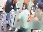 The accused (in black t shirt) as colleagues make a failed attempt to rescue the victim. (CCTV grab)
