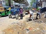 Workers repair the road cave in near Bharat Nagar Chowk in Ludhiana on Saturday. (Gurpreet Singh/HT) Workers repair the road cave in near Bharat Nagar Chowk in Ludhiana on Saturday. (Gurpreet Singh/HT)