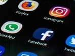 This photo illustration shows a mobile phone screen displaying the icons for the social networking apps Facebook.