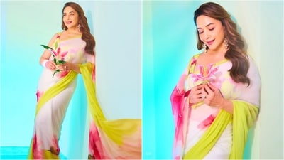Madhuri exudes regal charm in an ivory saree adorned with yellow borders and vibrant pink floral prints. Paired with a matching sleeveless blouse, the look is elegant. (Instagram/@madhuridixitnene) Madhuri exudes regal charm in an ivory saree adorned with yellow borders and vibrant pink floral prints. Paired with a matching sleeveless blouse, the look is elegant. (Instagram/@madhuridixitnene)