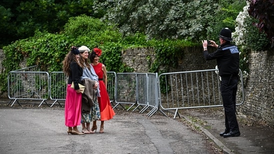 A Police officer takes pictures of attendees, on the day of the wedding of Princess Anne's son, Peter Phillips and Harriet Sperling in Kemble, Cirencester, Britain, June 6, 2026. REUTERS/Dylan Martinez(REUTERS)