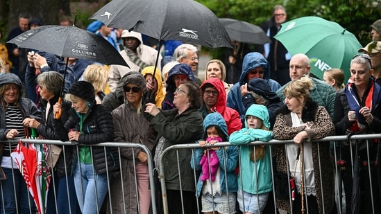 People use umbrellas to shield from the rain as they gather outside All Saints' Church, on the day of the wedding of Princess Anne's son, Peter Phillips and Harriet Sperling, in Kemble, Cirencester, Britain, June 6, 2026. REUTERS/Dylan Martinez(REUTERS)