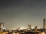 A projectile streaks through the sky over central Israel during an Iranian missile attack, Sunday, June 7, 2026. (AP Photo/Ohad Zwigenberg)