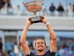 Germany’s Alexander Zverev lifts the trophy after winning the French Open men's final against Italy’s Flavio Cobolli in Paris on Sunday. (AP)