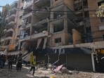Lebanese security officers gather at the site where an Israeli airstrike hit a building in Dahiyeh, Beirut's southern suburb, Lebanon,
