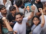 Cockroach Janta Party (CJP) founder Abhijeet Dipke holds a copy of the autobiography of Dr BR Ambedkar during a protest demanding the resignation of Union Education Minister Dharmendra Pradhan over alleged examination-related lapses, at the Jantar Mantar, in New Delhi, Saturday, June 6, 2026.