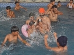 People make a splash to escape the sweltering summer heat in a pool on the outskirts of Amritsar on Sunday. (Sameer Sehgal/HT) People make a splash to escape the sweltering summer heat in a pool on the outskirts of Amritsar on Sunday. (Sameer Sehgal/HT)