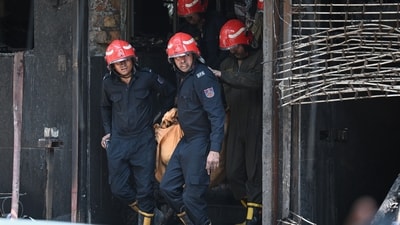 Firefighters and local residents rescue people from a building and shift them to nearby hospitals after a massive fire broke out at a bed-and-breakfast Restaurant and Hotel in the Malviya Nagar area in New Delhi, India, on Wednesday, June 3, 2026. (Hindustan Times)