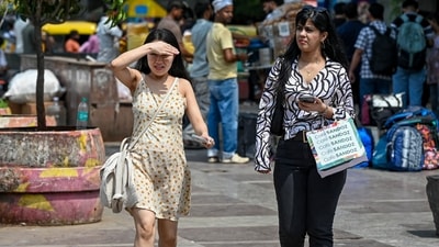 Gram it: Those stepping out during the day must not forgot to carry your umbrella! These young women must be regretting their miss as they walk around Connaught Place on a hot summer day. (Photo: PTI)