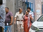 Family members and relatives of DU professor who was found murdered inside her apartment in East Delhi's Vasundhara Enclave, wait outside the mortuary, in Lal Bahadur Shastri hospital.