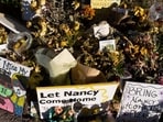 FILE - An ever-growing collection of yellow flowers and notes sit at the home of Nancy Guthrie, the missing mother of 