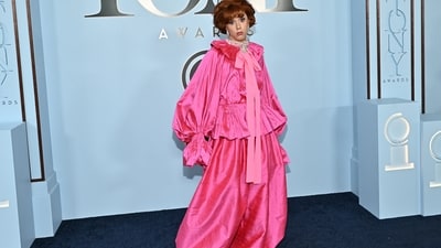 Cole Escola made a theatrical statement in a striking bright-pink ensemble by Christopher John Rogers. The avant-garde look stood out for its voluminous puff sleeves, vibrant silk taffeta fabric, and dramatic silhouette. The electric-pink set featured a collared blouse with gathered sleeves, an elongated necktie that cascaded down the front, and wide-leg trousers. (AP Photo/Evan Agostini) Cole Escola made a theatrical statement in a striking bright-pink ensemble by Christopher John Rogers. The avant-garde look stood out for its voluminous puff sleeves, vibrant silk taffeta fabric, and dramatic silhouette. The electric-pink set featured a collared blouse with gathered sleeves, an elongated necktie that cascaded down the front, and wide-leg trousers. (AP Photo/Evan Agostini)