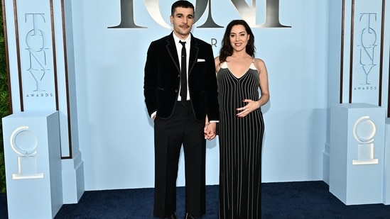 Aubrey Plaza and Chistopher Abbott made their red carpet debut, as the mom-to-be radiated joy in her pregnancy glow. Aubrey wore a striped black-and-white A-line gown that perfected hugged her baby bump, while Christopher looked sharp in a crisp black velvet suit.(AP Photo/Evan Agostini)
