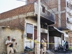 Jaipur: Police officials at the site after a fire broke out in a factory operated in a small house in Jaipur's Kho-Nagorian area. (PTI)