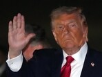 President Donald Trump gestures as he steps off Air Force One, early Tuesday at Joint Base Andrews, Maryland. (AP)