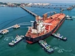  Tugboats move a crude oil tanker to its berth at the oil terminal at the port in Qingdao, in China's eastern Shandong province on June 8, 2026. 
