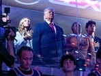 US President Donald Trump with his grand daughter Kai Trump (L), Knicks owner James Dolan (3L), US Secretary of the Interior Doug Burgum (3R) and Environmental Protection Agency director Lee Zeldin (2R) attend Game Three of the NBA Finals between the San Antonio Spurs and the New York Knicks at Madison Square Garden in New York on June 8, 2026. (Photo by SAUL LOEB / AFP)