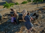 Israeli settlers near a downed Iranian missile Monday on the outskirts of Jericho.