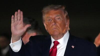 President Donald Trump gestures as he steps off Air Force One, early Tuesday at Joint Base Andrews, Maryland. (AP)