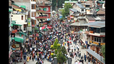 Tourists strolling on the Mall road in Manali on Tuesday. (Aqil Khan /HT) Tourists strolling on the Mall road in Manali on Tuesday. (Aqil Khan /HT)