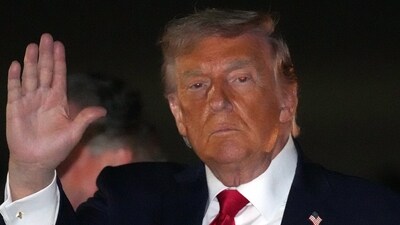US President Donald Trump gestures as he steps off Air Force One, early Tuesday. (AP Photo) US President Donald Trump gestures as he steps off Air Force One, early Tuesday. (AP Photo)