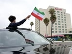 A person waves an Iranian flag from a vehicle outside the hotel where Iran's players are staying following their arrival in Tijuana, Mexico, on June 7, 2026, ahead of the FIFA 2026 World Cup football tournament. (AFP)