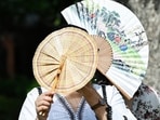 Gram it: Fans don't just provide cool air but also come in handy to protect oneself. As the temperature in the Capital rose to 43 degrees Celsius on Wednesday, here's how a woman used not one but two hand fans to guard herself from the scorching sun. 